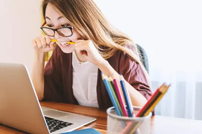 Woman looking at her laptop with some frustration